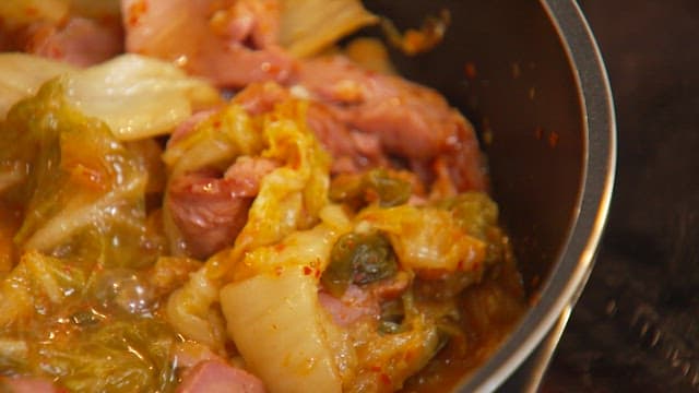 Cooking spicy kimchi stew with smoked duck