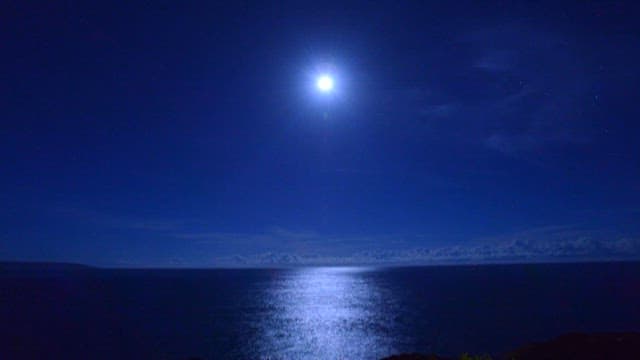 Moonlit Night Sky Over Ocean Horizon