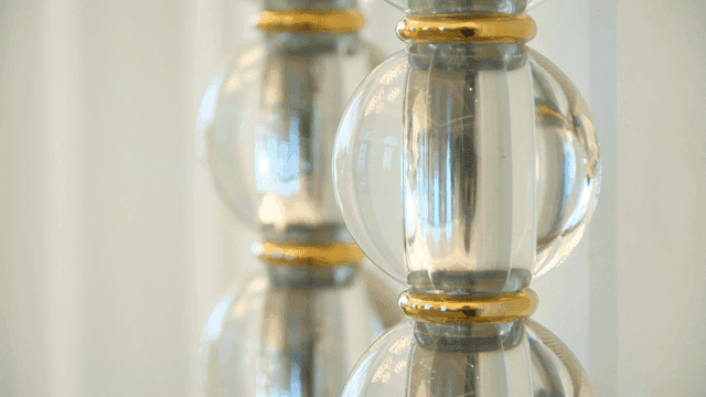 Glass bead decoration with gold rings