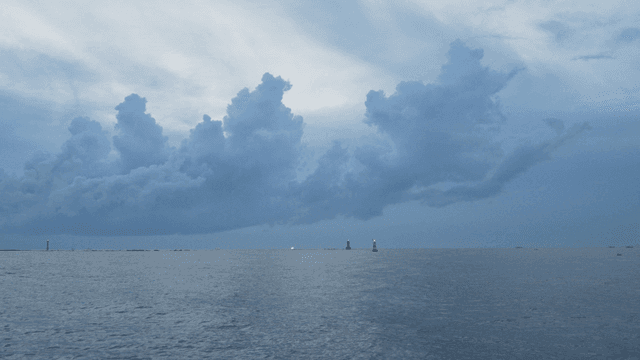 Calm sea under a cloudy sky