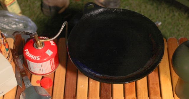Preparing a meal outdoors with a portable stove