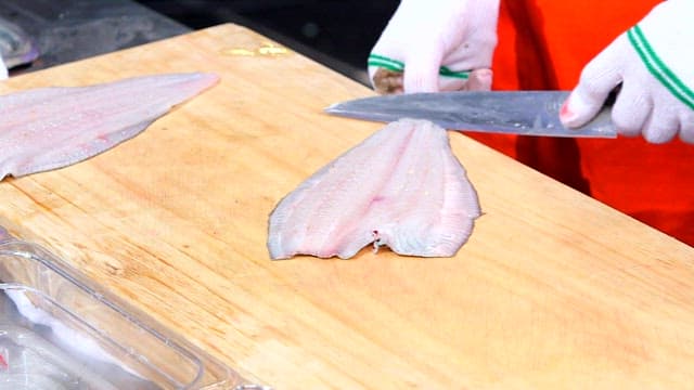 Filleting flatfish on a wooden cutting board