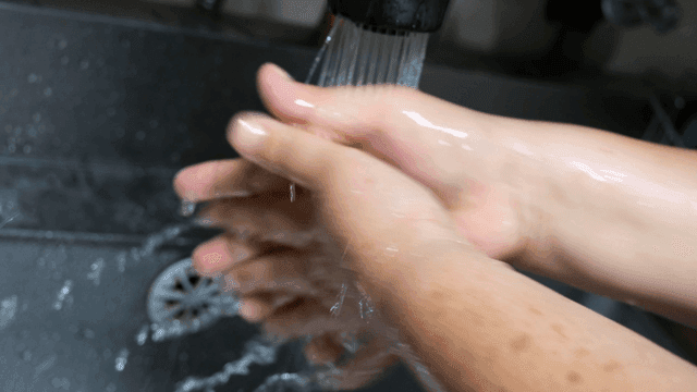 Hands being washed under running water