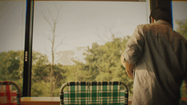 Back of person sitting by window