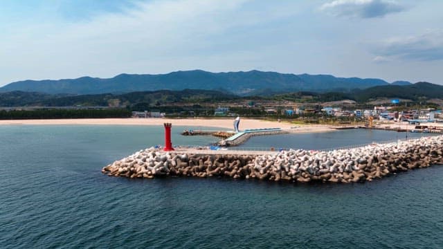 Coastal view with a red lighthouse