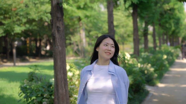 Woman smiling while walking in a park