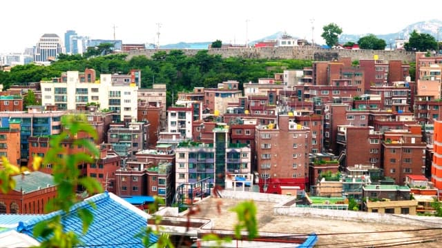 Panoramic view of a densely populated city with buildings and greenery