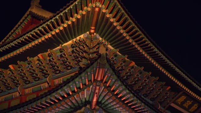 Geunjeongjeon Hall of Gyeongbokgung Palace lit up under the moonlight of a dark night