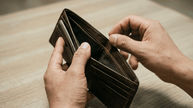 Hand putting 500-won coin into wallet