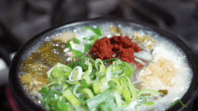 Beef hangover soup topped with green onions and seasoning sauce