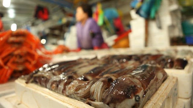 Market Vendor with Fresh Seafood