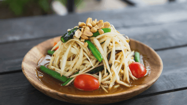Plate of papaya salad and Som Tum topped with peanuts