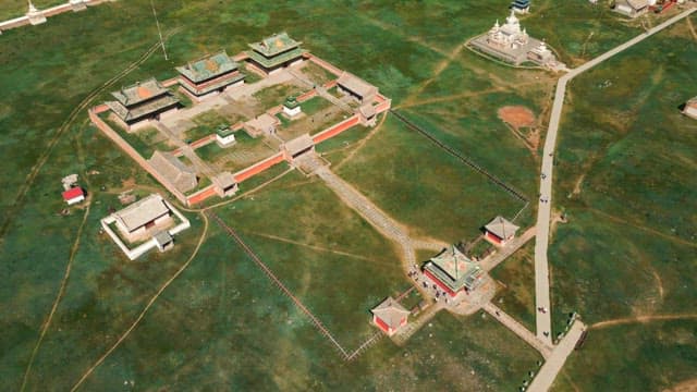 Historic temple complex in a vast green field