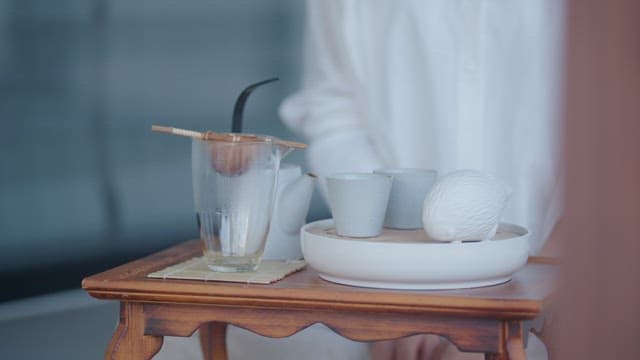 Person Leisurely Brewing Tea Indoors