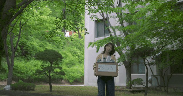 Woman carrying a box outdoors