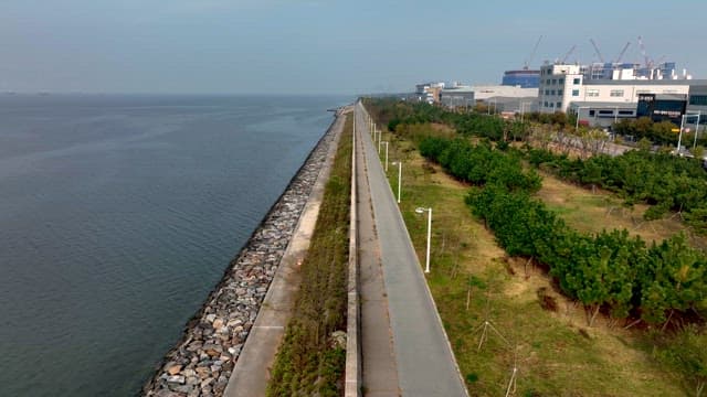 Quiet Coastal Road Next to an Industrial Area