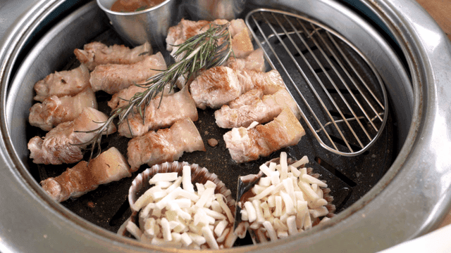 Grilled pork belly with cheese clams and herbs