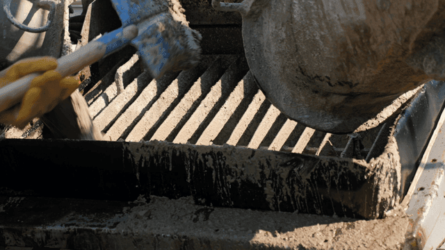 Concrete being poured from a mixer