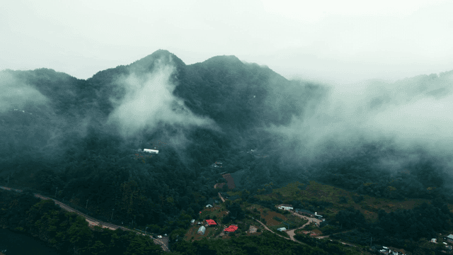 Misty mountains with scattered clouds