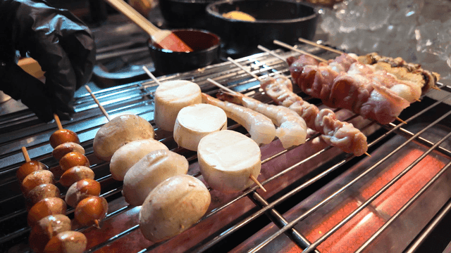 Various skewers grilling on a barbecue