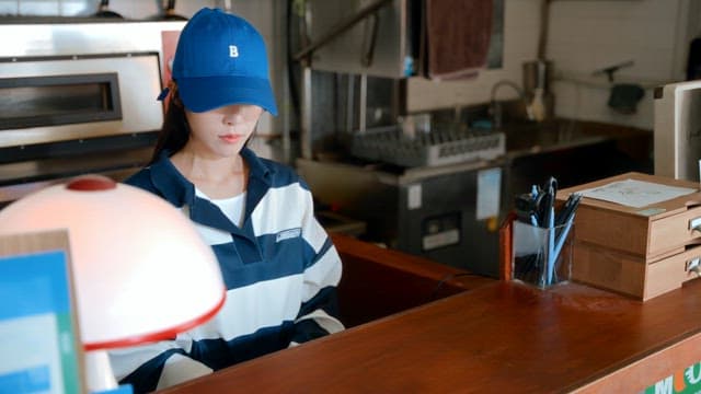 Woman handing over a card and an employee making payment