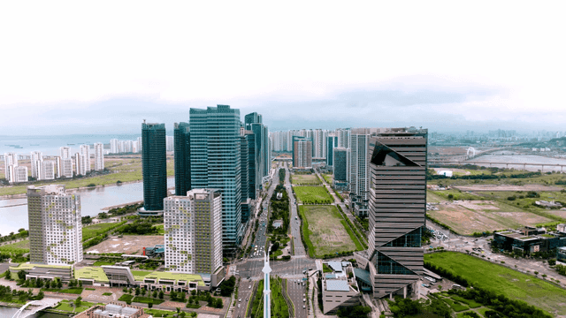City view with wide road and park in center