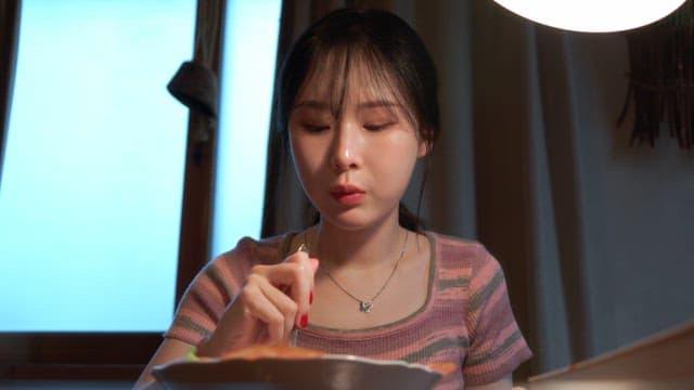 Woman enjoying a meal indoors