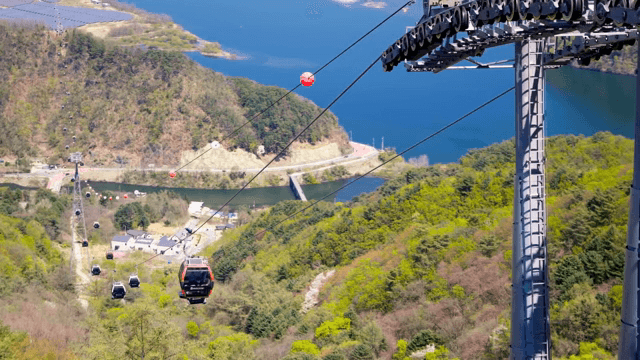 Cable cars over a scenic mountain landscape