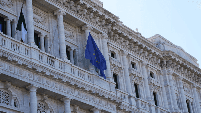 Facade of a historic building with flags