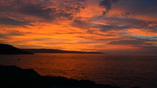 Fiery Sunset Over a Tranquil Sea