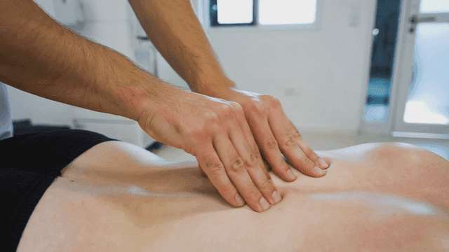 Massage therapist who performs back massages