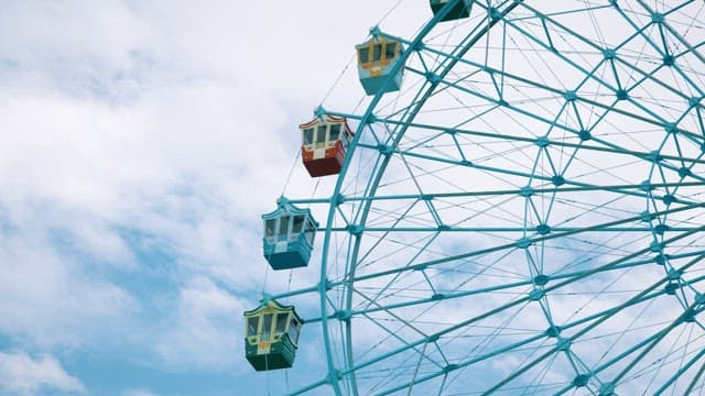 Serene Ferris Wheel Against Cloudy Sky