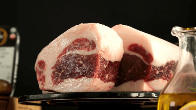 Thick slices of beef served on plate with olive oil
