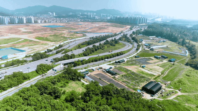 Aerial view of a city with highways and fields