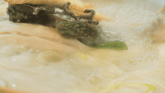 Haeshintang with abalone and chicken boiling in broth