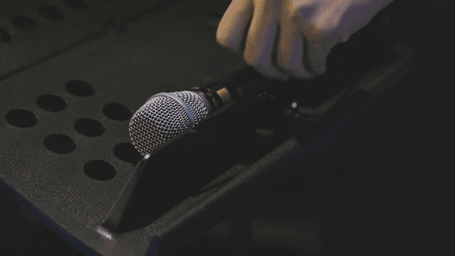 Microphone on a music stand in a dim room