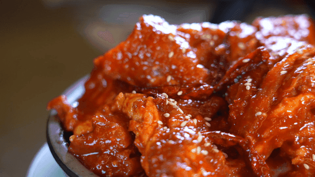 Spicy gochujang marinated short ribs sprinkled with sesame seeds