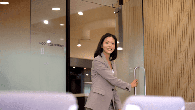 Working woman entering meeting room