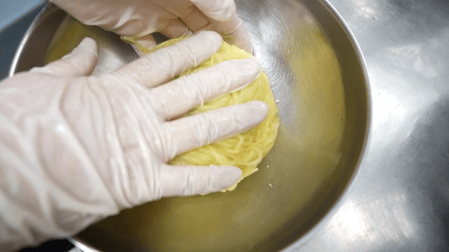 Preparing noodles in a kitchen