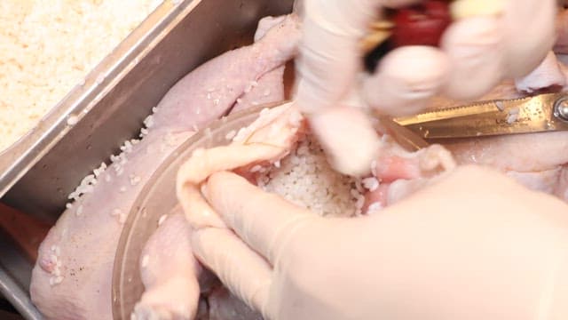 Preparing Traditional Stuffed Chicken Dish with Dates and Ginger