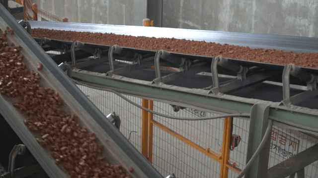 Conveyor belt transporting soil