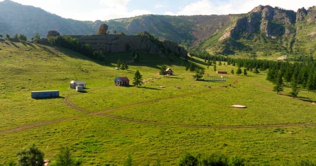 Vast green valley with houses