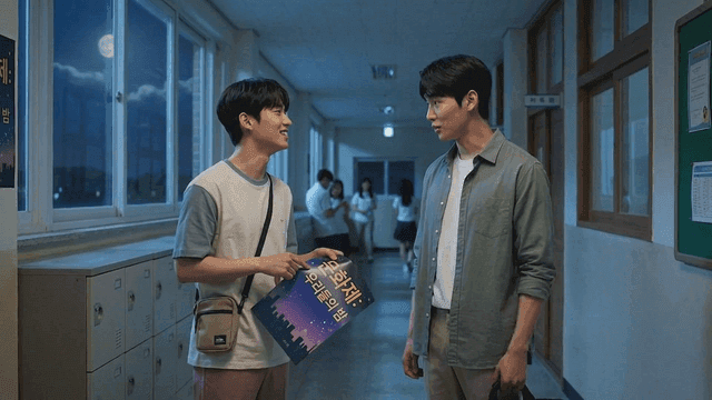 Students talking in a school hallway at night
