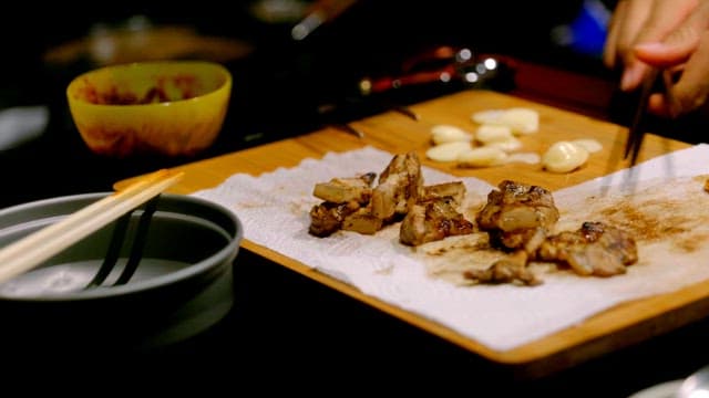 Eating grilled pork belly at a campsite