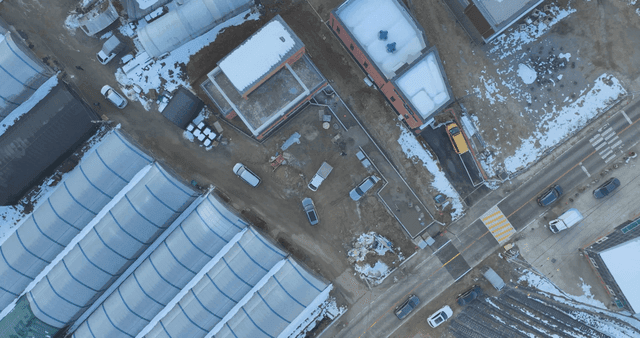 Snow-covered farms and roadside greenhouses