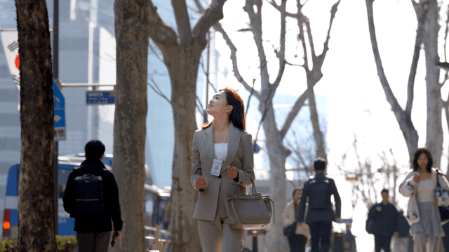 Working woman walking on city street