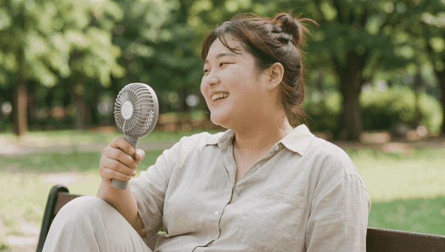 Plump woman enjoying cool breeze in park