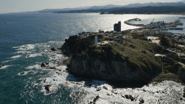 절벽 위 흰색 등대가 있는 해안 마을