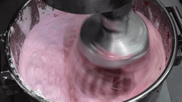 Mixing cream in a metal bowl