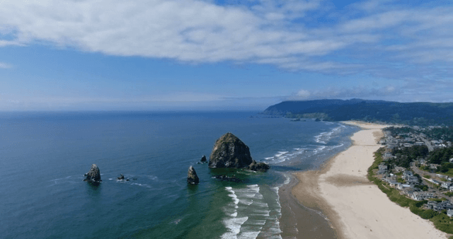 A serene beach with waves and rocky formations